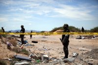 A crime scene investigation of two dead bodies found in the desert outside of Juarez. Mexico, on Aug. 2, 2009.