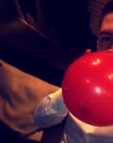 Another party goer is seen inhaling a substance through a balloon, believed to be nitrous oxide