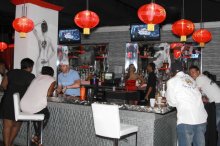 Patrons hang out at the main bar inside Zen Exotic Lounge and Club in downtown Orlando.